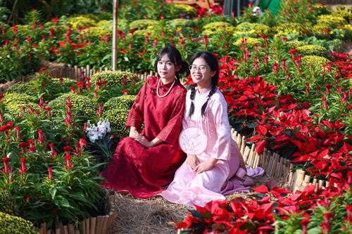 Tourists flock to check in at the spring flower garden next to the metro station.